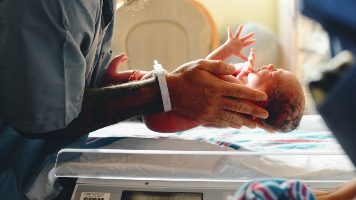 Newborn baby being weighed at the hospital just after birth