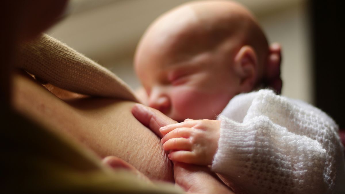 mother breastfeeeding her baby
